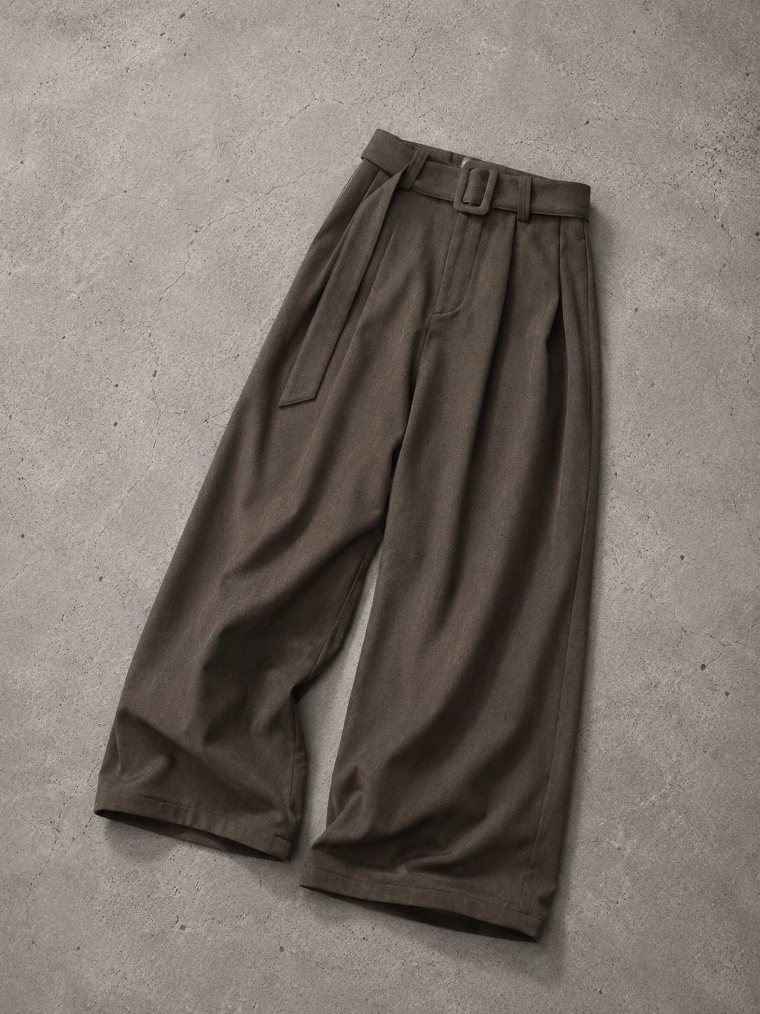 Brown wide-leg pants on a gray concrete surface