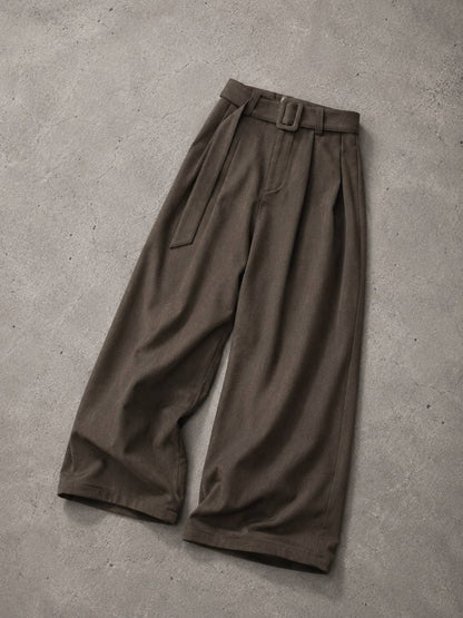 Brown wide-leg pants on a gray concrete surface