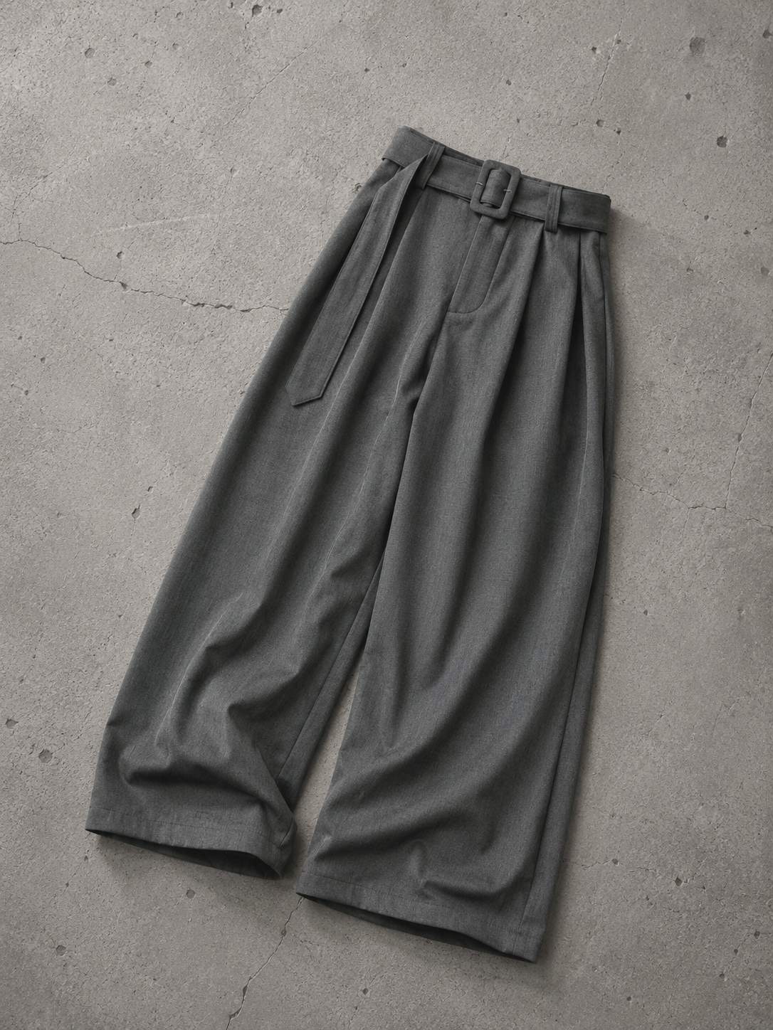 Gray wide-leg pants on a concrete floor