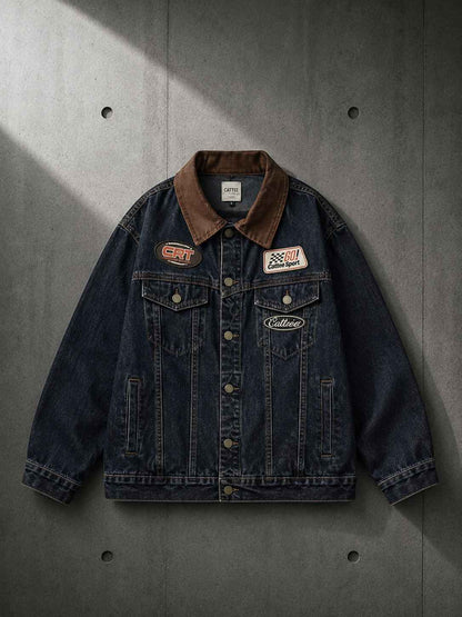 Denim jacket with patches on a gray concrete background