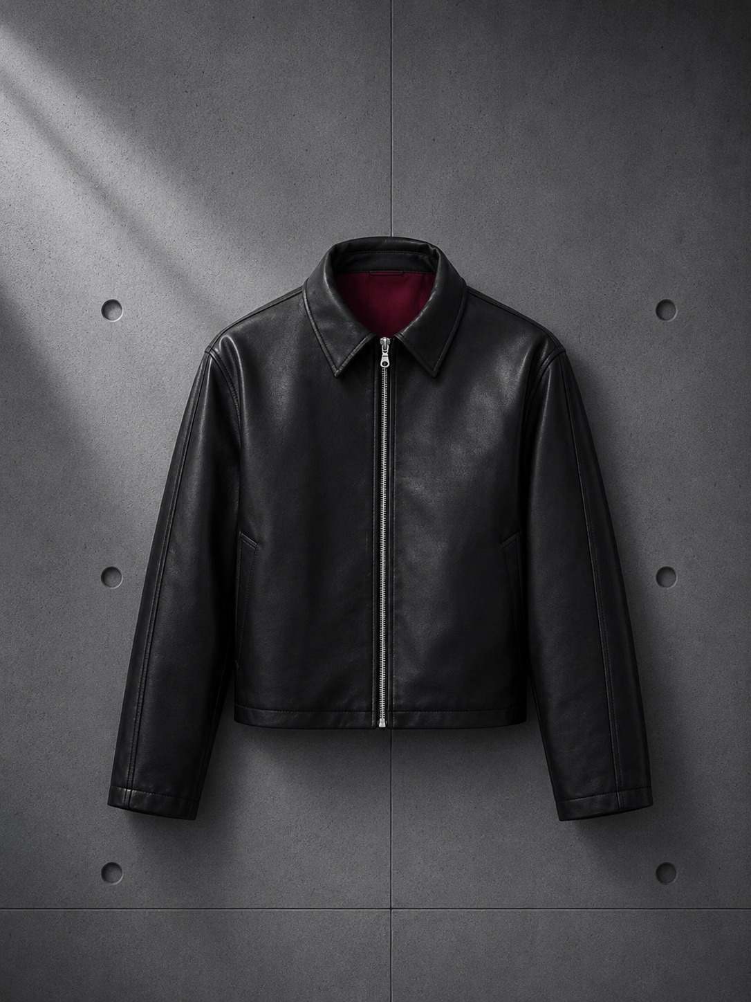 Black leather jacket on a gray concrete background