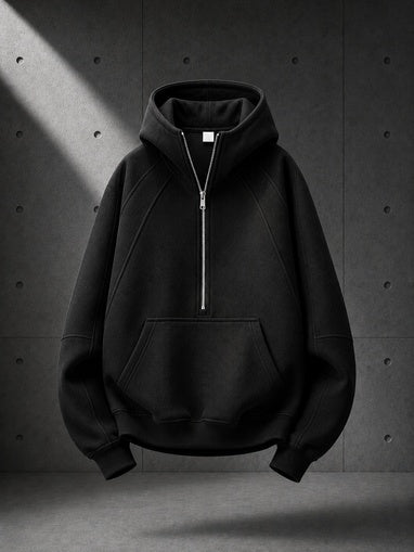 Black hoodie with a zipper on a dark gray background