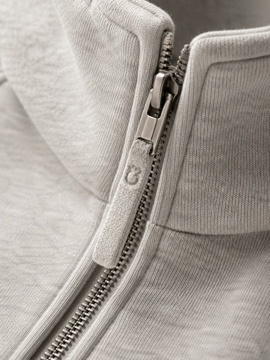 Close-up of a zipper on a gray jacket