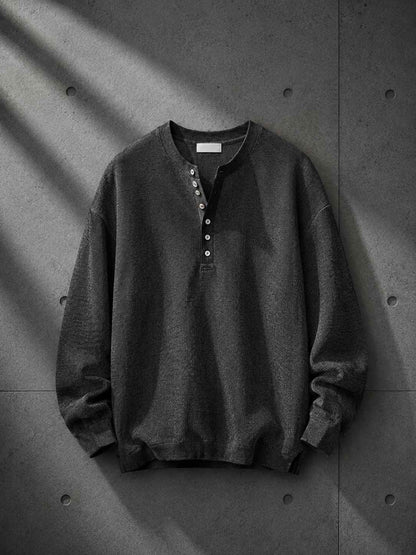 Dark gray sweatshirt on a textured gray background