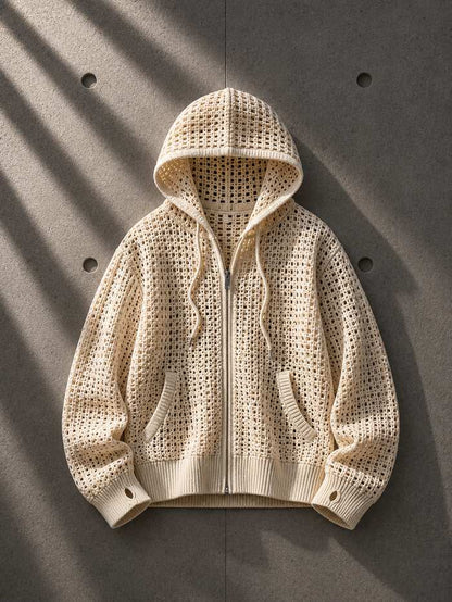 Beige knitted hoodie on a gray background