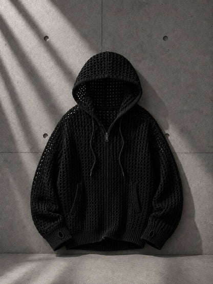 Black textured hoodie on a concrete surface with shadows