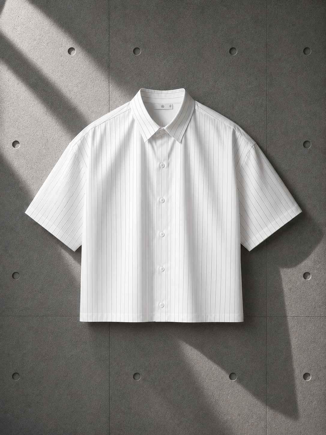 White short-sleeve shirt on a gray textured background