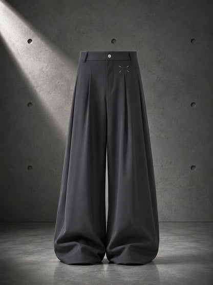 Black wide-leg pants on a gray concrete background