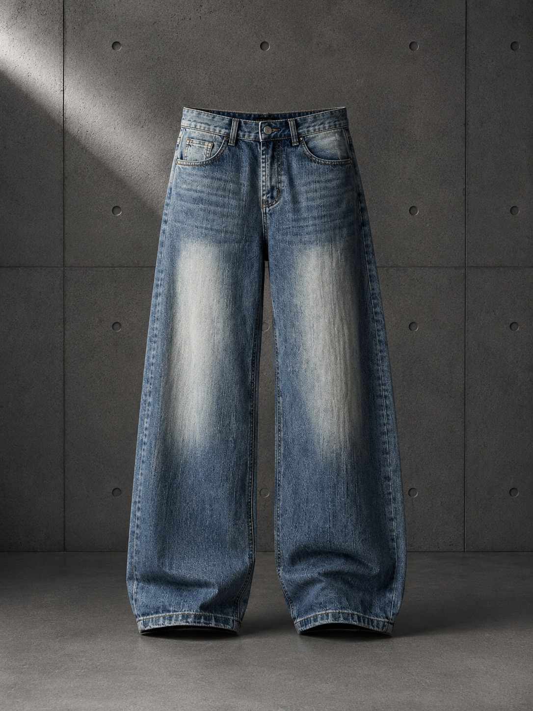 Pair of blue jeans on a gray concrete background