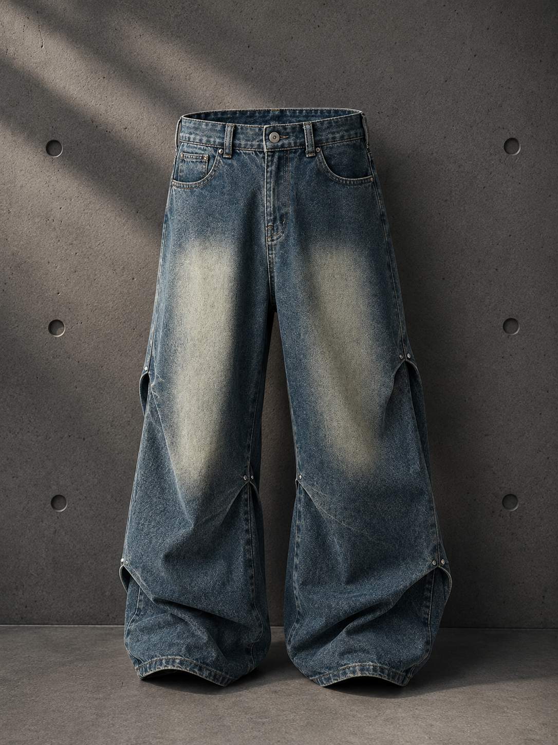 Blue jeans with a distressed look on a gray background