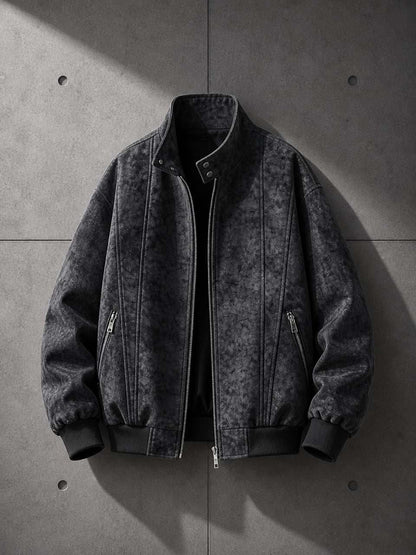 Dark gray bomber jacket on a concrete surface