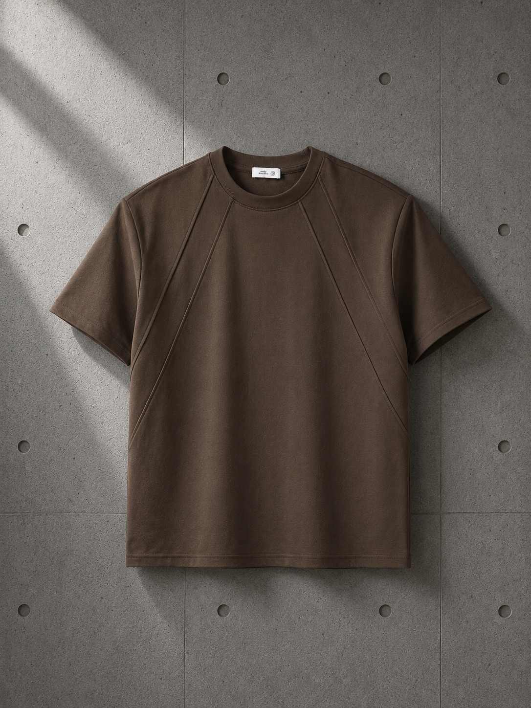 Brown t-shirt on a gray concrete surface