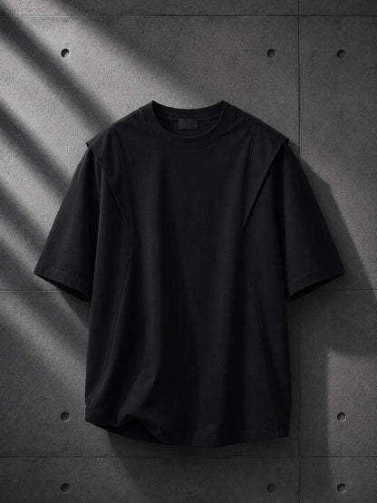Black t-shirt on a textured gray surface
