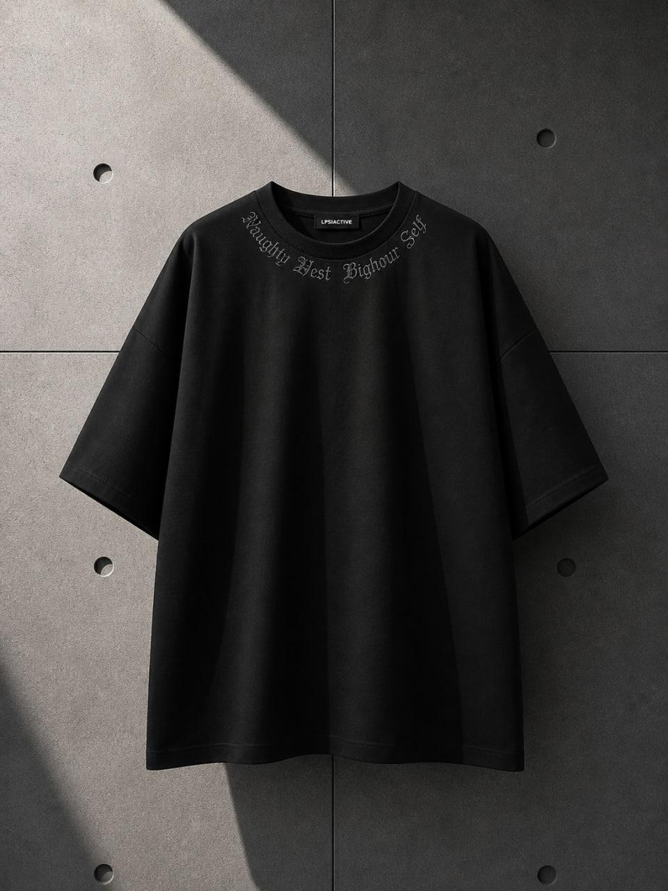 Black t-shirt with text on a gray concrete background