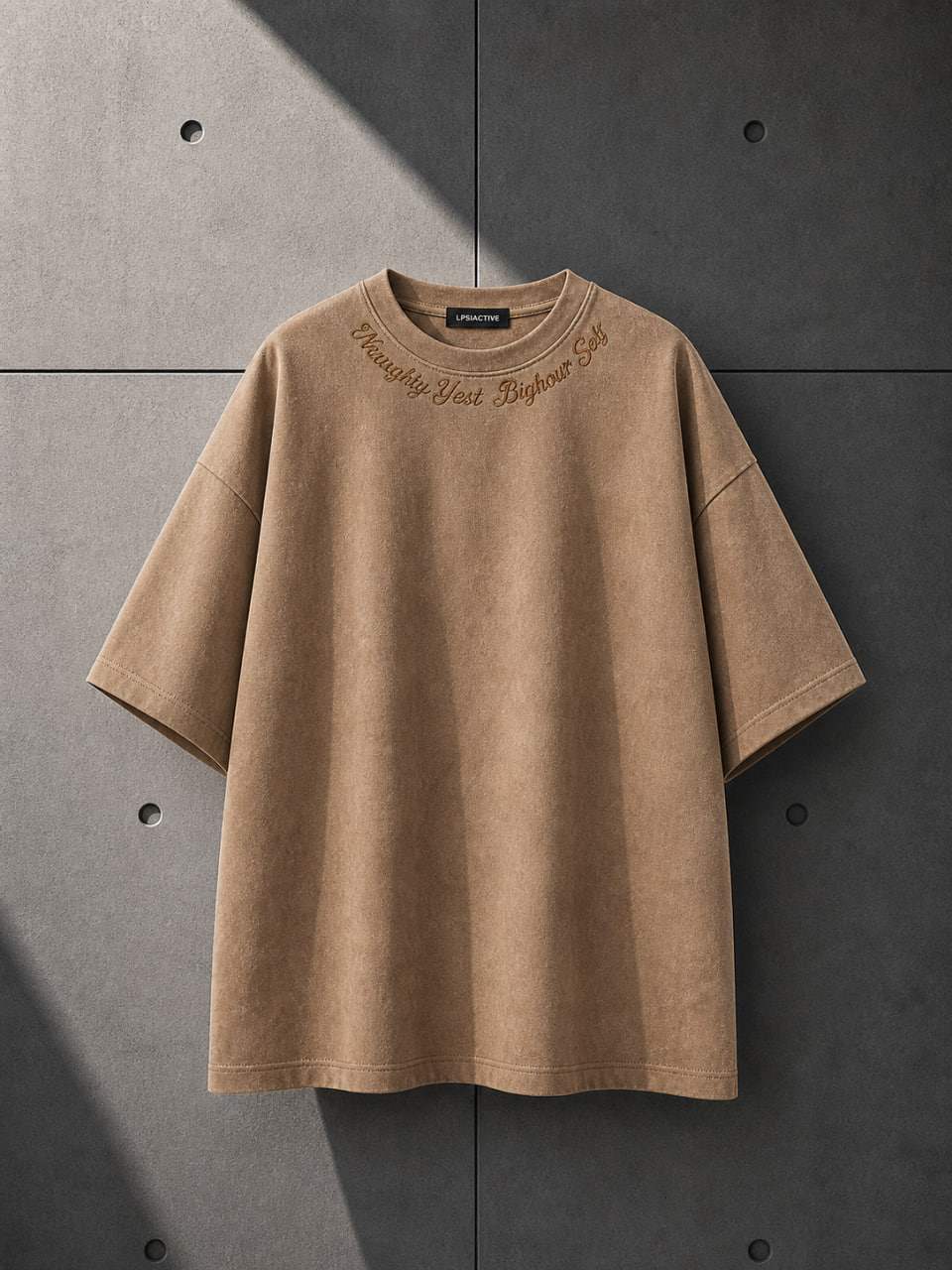 Brown t-shirt with embroidery on a gray concrete background