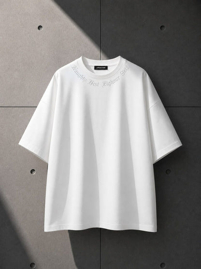 White t-shirt with text on a gray background
