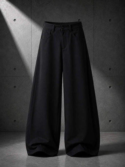 Black wide-leg pants on a gray concrete background