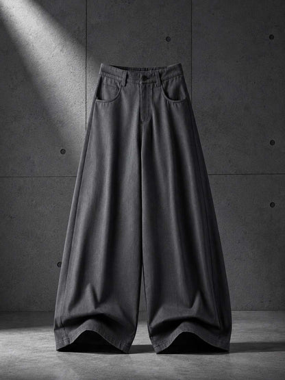 Dark gray wide-leg pants on a concrete floor with a spotlight effect.