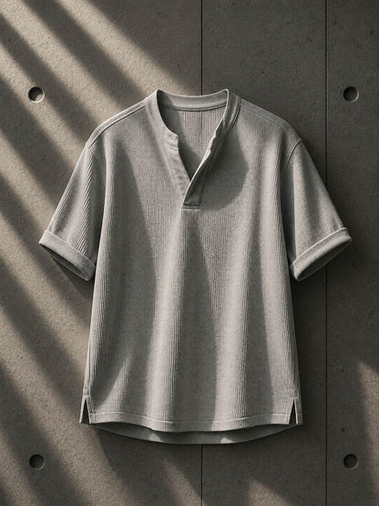 Gray short-sleeve shirt on a textured gray background