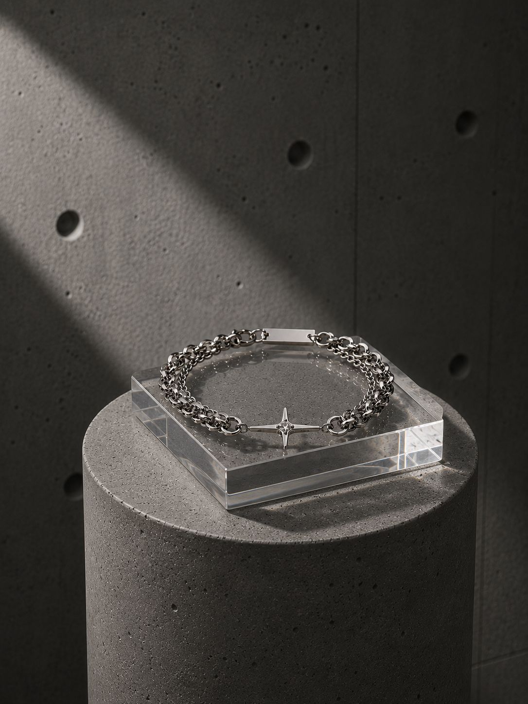 Bracelet on a clear stand against a dark concrete background
