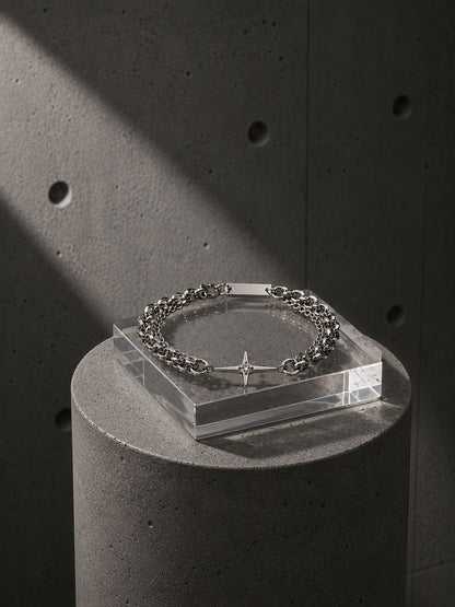 Bracelet on a clear stand against a dark concrete background