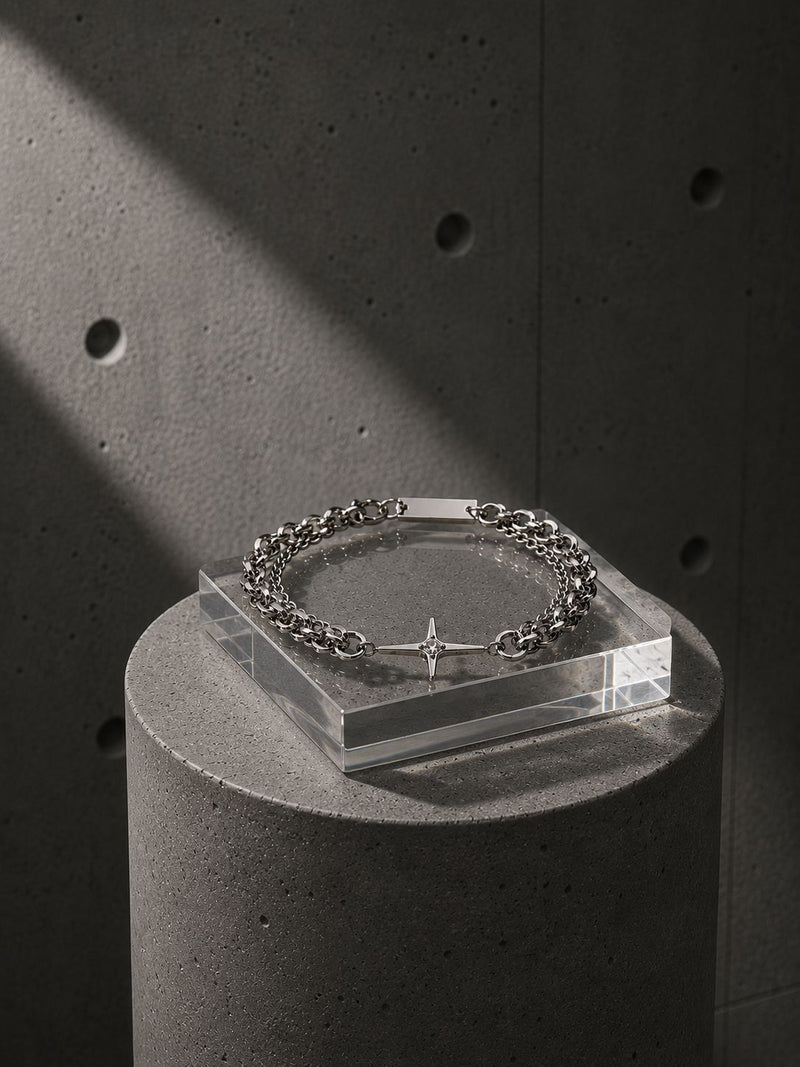 Bracelet on a clear stand against a dark concrete background